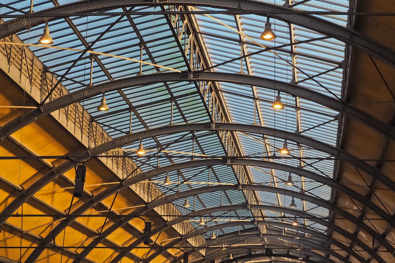 Detailed view of a futuristic glass and steel arched ceiling with geometric design.